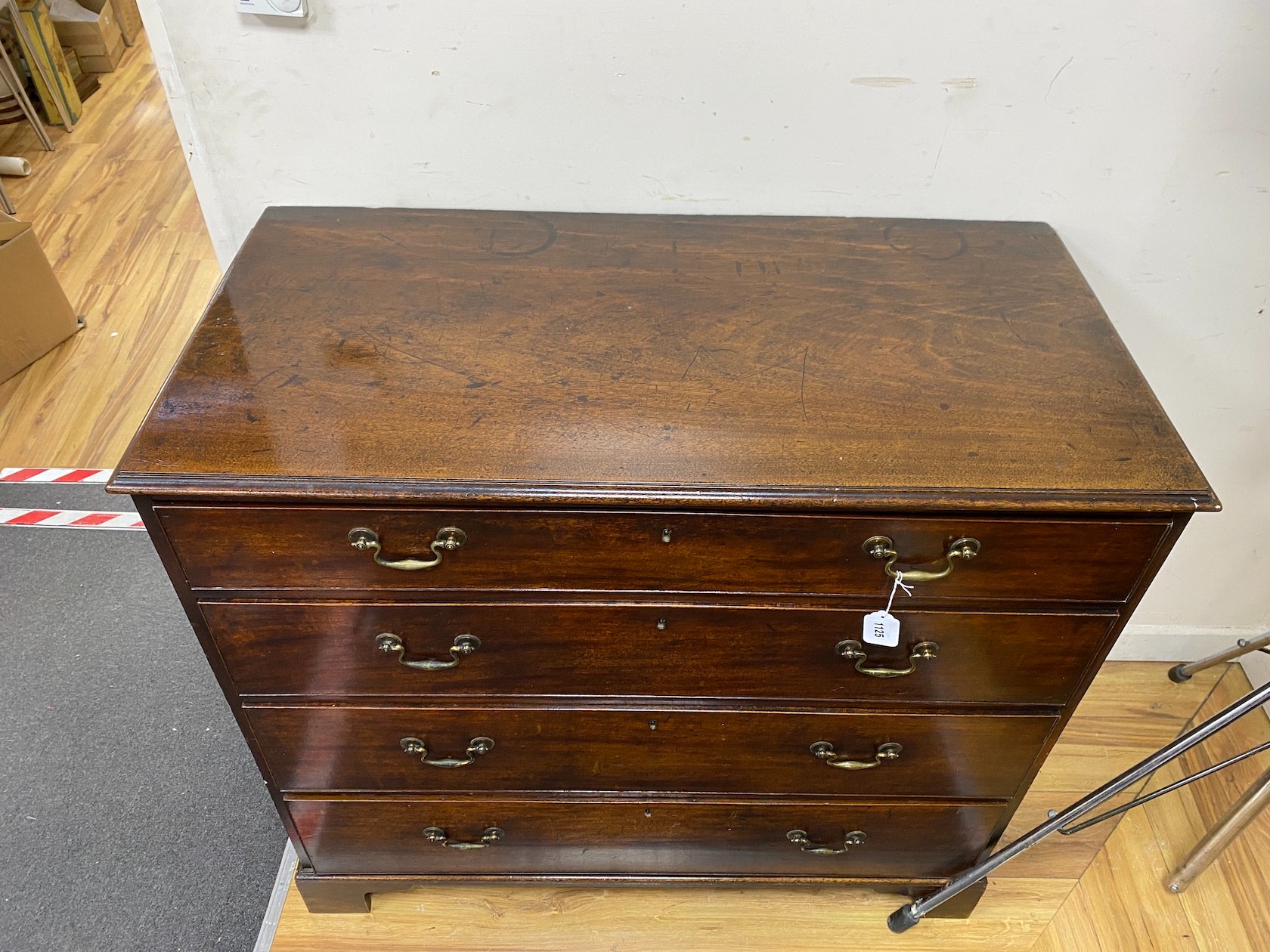 A George III mahogany chest of four graduating long drawers, height 97cm width 107cm depth 54cm